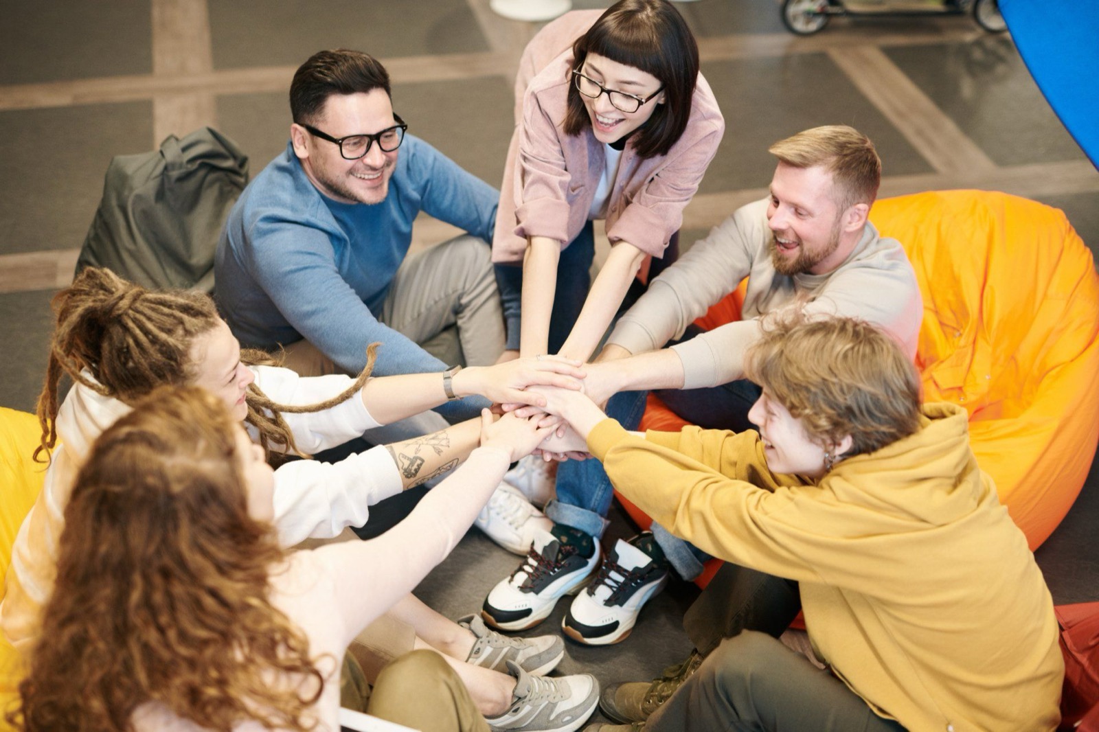 Team stacking hands together in a circle